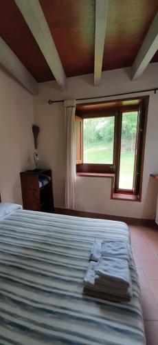 a bedroom with a bed and a window at El Serrat Turisme Rural in Planoles