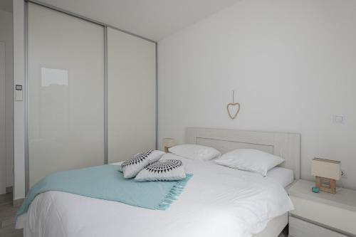 a white bed with two pillows on top of it at Korcula Hill in Korčula