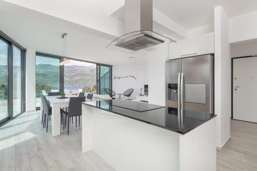 a kitchen and dining room with a table and chairs at Korcula Hill in Korčula