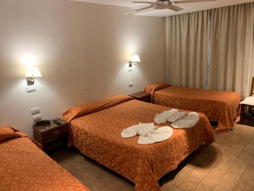 a hotel room with two beds with towels on them at Hotel Select in Mar del Plata