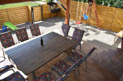 a wooden table and chairs on a patio at Relax Morava in Velké Bílovice