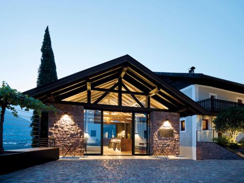 a house with glass doors and a building at Pratenberg Wine Lodge in Merano