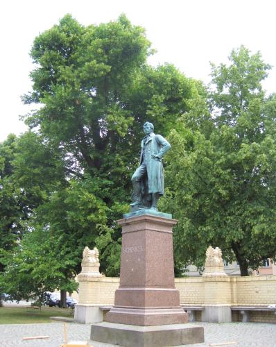 a statue of a man on a pedestal in a park at Travel Art Boardinghouse in Neuruppin