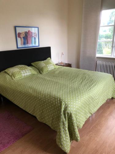 a bedroom with a bed with a polka dot bedspread at MästreBo in Timrå