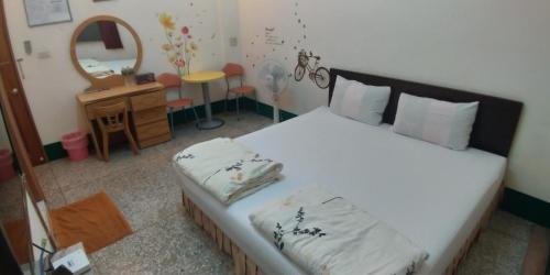 Postel nebo postele na pokoji v ubytování Sun Wu Homestay