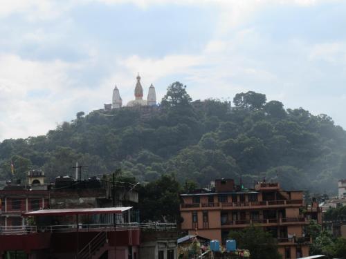 a mountain with two domes on top of it at STUPA VIEW INN in Kathmandu