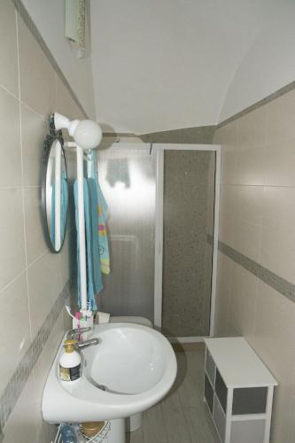 a bathroom with a white sink and a shower at Residenza Giannini a Termoli in Termoli