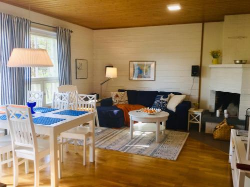 a living room with a table and a couch at Herranterttu Apartments in Saariselka