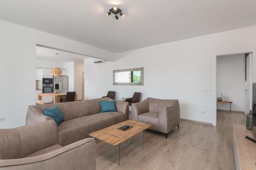 a living room with a couch and two chairs and a table at Korcula Hill in Korčula