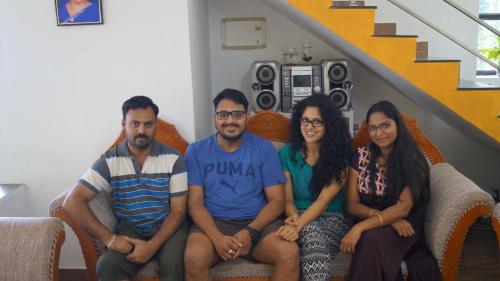 a group of people sitting on a couch at Grace Inn Munnar Homestay in Munnar