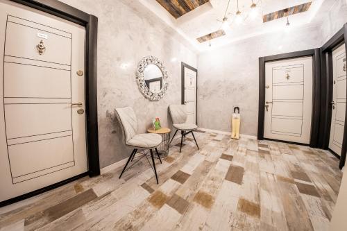a room with two chairs and a table and two doors at Sofia Colour Life Apartment -No Window Apartment in Sofia