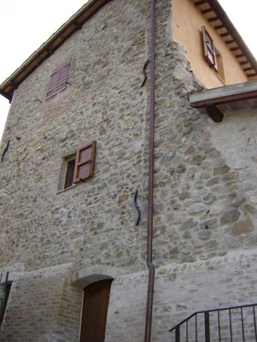a tall stone building with windows on the side of it at Casale del Monsignore in Spoleto