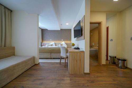 a hotel room with a bed and a desk and a bedroom at Grand Hotel BELLEVUE in Smokovce