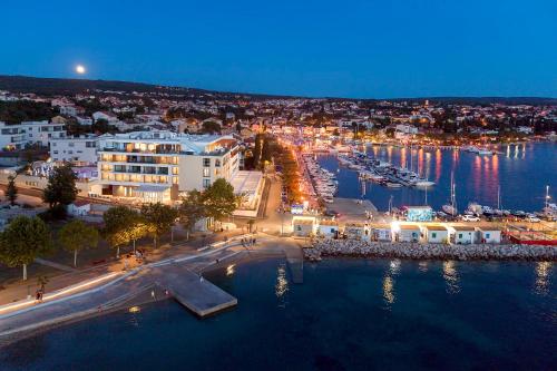 an aerial view of a harbor at night at Luxury Hotel Riva in Malinska