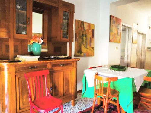a dining room with a table and two chairs and a table and chairsktop at Amariglio in Ozieri