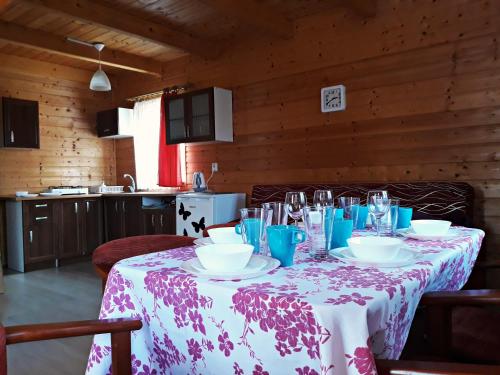 a table with a pink and white table cloth on it at Mandarynka OW in Jarosławiec