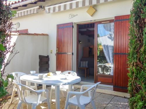 a white table and chairs on a patio at Holiday Home La Coralline-3 by Interhome in Vaux-sur-Mer