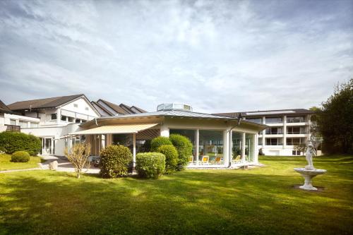 a large white building with a green yard at Hotel Traube Revital in Wurmlingen