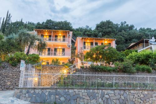 a building with a fence in front of it at Villa Maria Makri in Paleokastritsa