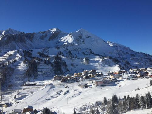 a small village in the snow with a mountain at Andi's Skihotel in Obertauern
