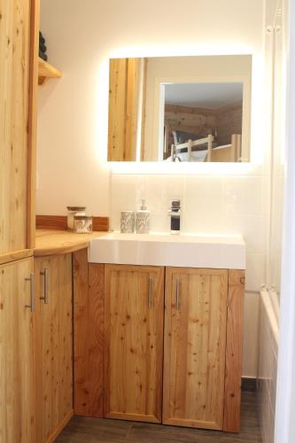 a bathroom with a sink and a mirror at La Chamoisiere Montgenevre in Montgenèvre