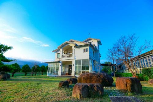 a house with logs in front of it at Star House in Tianfu