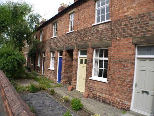 a brick building with white and blue doors at 22 Mill Road in Lincoln