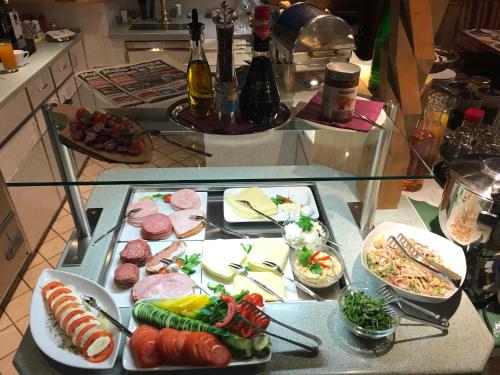 a glass table with plates of food on it at Andi's Skihotel in Obertauern