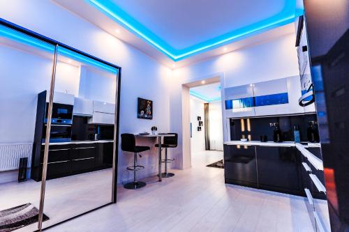 a room with a kitchen with a blue ceiling at Luxury Smart Apartments in Szeged
