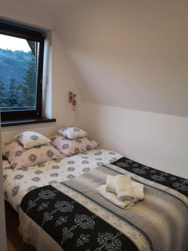 a bedroom with two beds with pillows and a window at Willa Seba in Zakopane