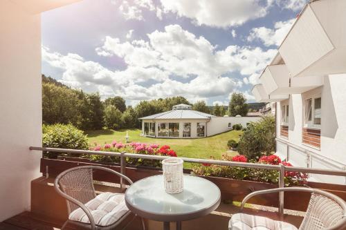 a balcony with a table and chairs and a house at Hotel Traube Revital in Wurmlingen
