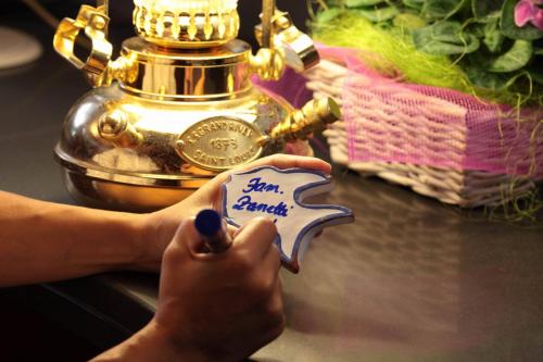 a person holding a piece of paper with the words happy bank at Piccolo Hotel in Moneglia