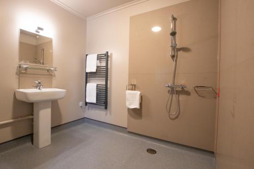 a bathroom with a sink and a shower at The Cherry Tree Rochford in Rochford