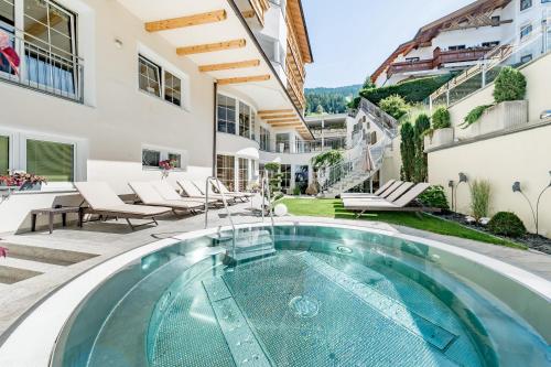 a swimming pool in the backyard of a house at Hotel Andy 4 Sterne Superior in Jerzens