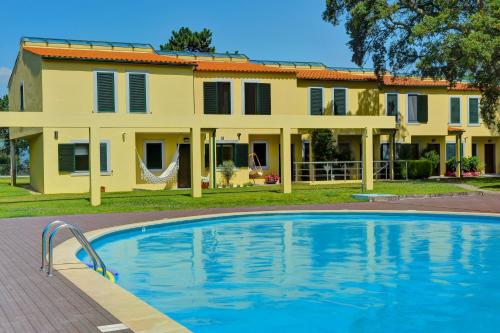 a house with a swimming pool in front of a house at Quinta Da Boavista- Casa N in Caminha