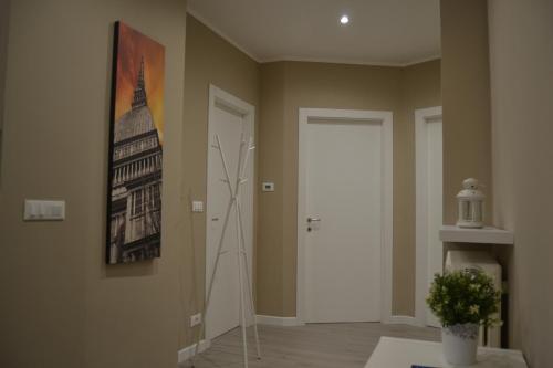 a hallway with a white door and a painting on the wall at DOMUS LINGOTTO in Turin