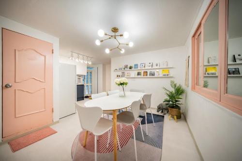 a dining room with a white table and chairs at YAB-GuestHouse, FemaleOnly, ForeignOnly in Seoul