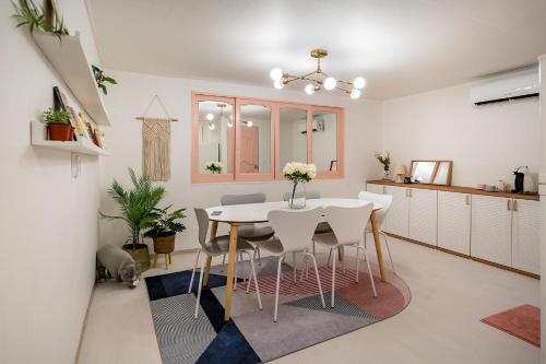 a kitchen and dining room with a white table and chairs at YAB-GuestHouse, FemaleOnly, ForeignOnly in Seoul