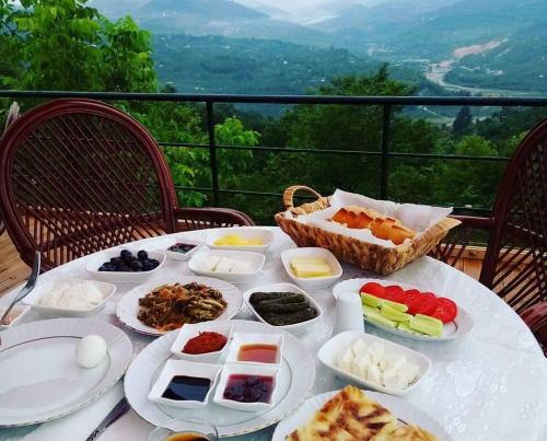 a table with plates of food on top of a table at Hayat Oksijen Resort in Ordu