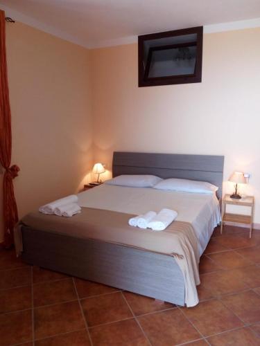 a bedroom with a bed with two towels on it at B&B Dimora Marchese in Marina di Camerota