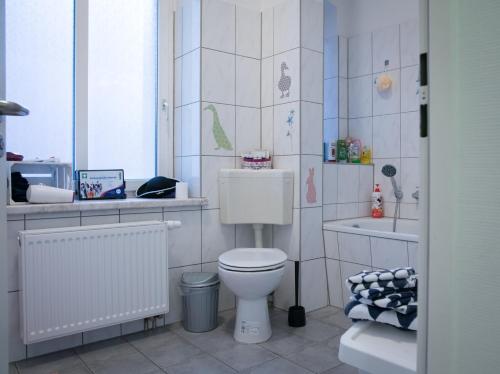 a small bathroom with a toilet and a sink at KINDheitstRAUM in Erfurt