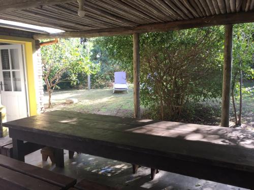 a patio with a table and a chair in a yard at Casa Azul in Maldonado