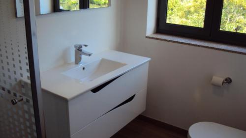 a bathroom with a sink with a faucet at Alojamento Rodrigues in Arcos de Valdevez