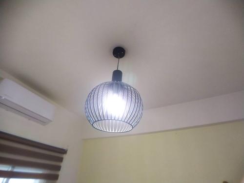 a light hanging from a ceiling in a room at 玖拾捌民宿-98bnb in Hualien City