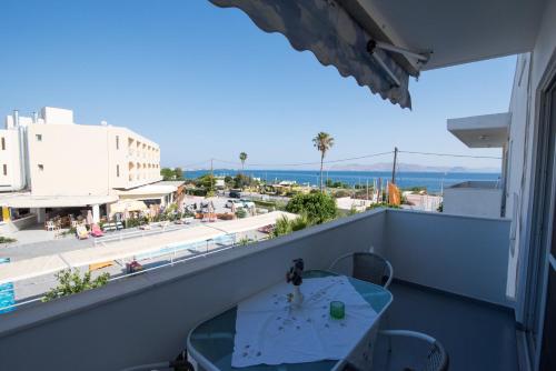 a balcony with a table and a view of the beach at KOS Family House in Psalidi
