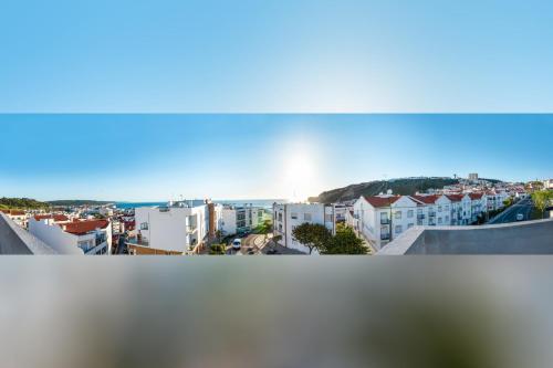 a view of a city with white buildings at Paz & Amor Guest House - Peace & Love in Nazaré