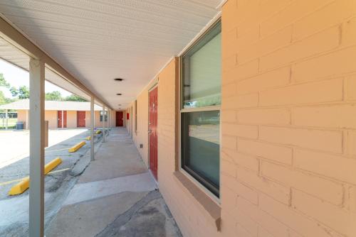 an empty hallway of a school building with windows at Budget Inn & Suites Baton Rouge in Baton Rouge