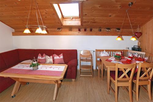 a living room with a couch and a table and chairs at Ferienhof Kleber Bauernhof - mit KönigsCard in Seeg