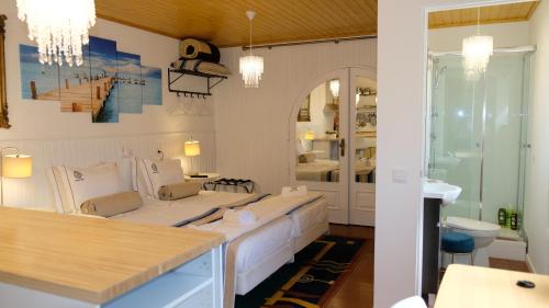 a room with a bed and a bathroom at PH in Atlantic Coast in Charneca
