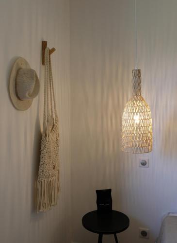 a room with a hanging bag and a table at "Au jardin sur l'eau" Hortillonnages in Amiens